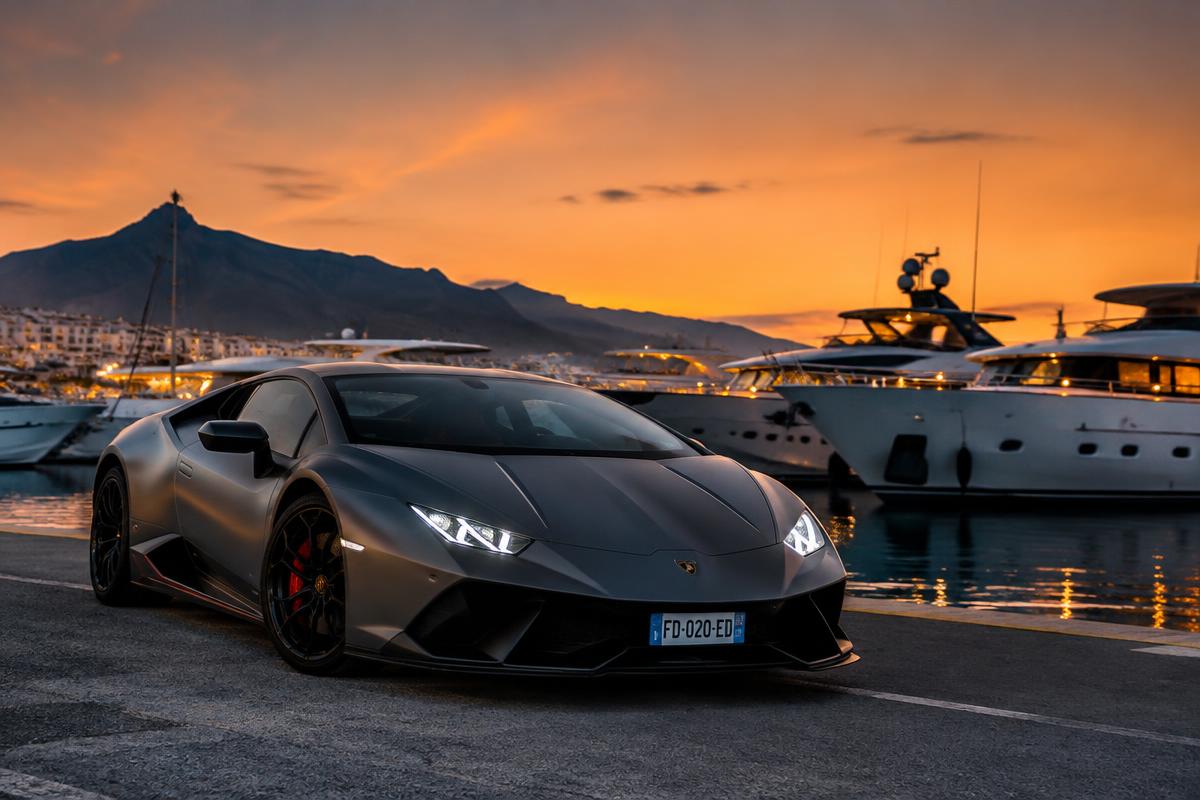 Lamborghini supercar at a Costa del Sol marina at dusk